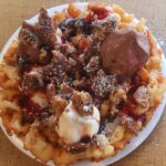 A photo of our signature funnel cake at Loaves and Fishes Family Kitchen in Temiskaming Shores. Restaurant and food truck serving Thornloe, New Liskeard, Cobalt, Earlton, Engelhart, and surrounding Ontario towns.